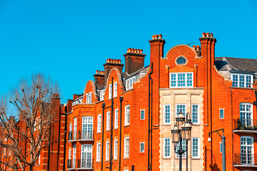 Low angle view of a traditional red brick apartment block in Kensington and Chelsea, London