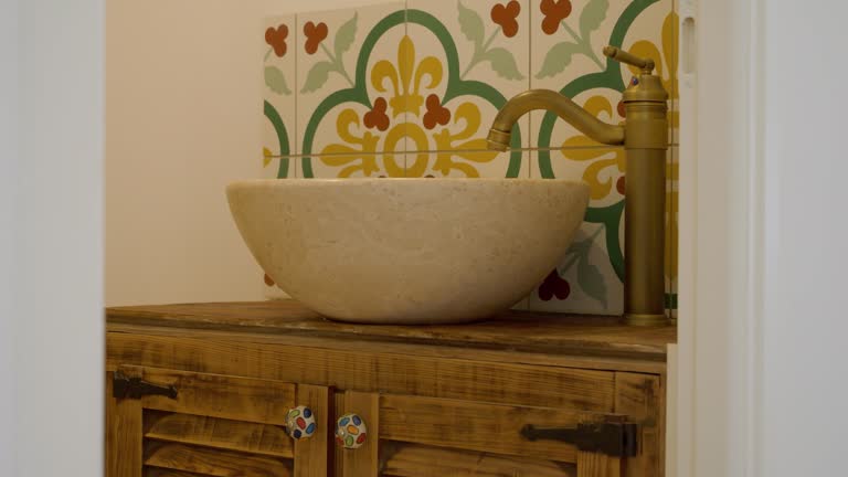 Slow revealing shot of an antique design bathroom with washbasin on a cabinet