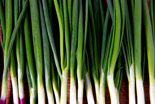 Fresh green onion on rustic wooden tables