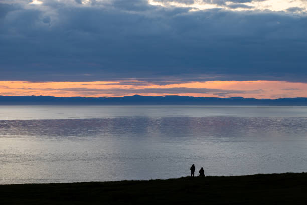 Sunset over the Puget Sound with Olympic Mt range in distance from Whidbey Island WA