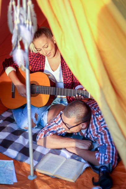 istock Happy young couple and their dog camping 2150577570
