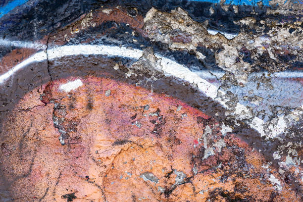 istock Dark blue and orange old plastered wall with chipped paint. Texture for background 2150577700