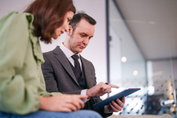 istock Business man and his assistant using digital tablet in office hall. 2150577995