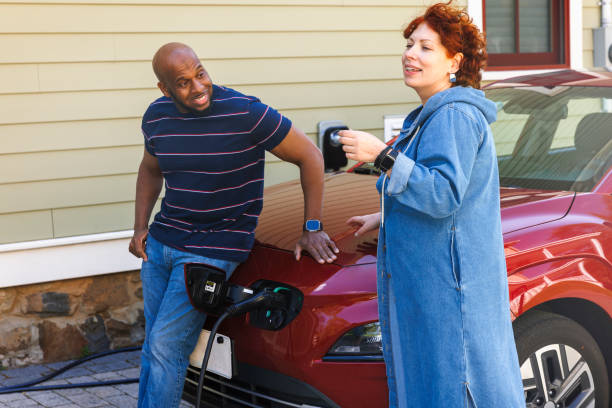istock Sustainable development and innovative technologies in daily life. Joyful interracial couple charging EV in suburban area 2150578426