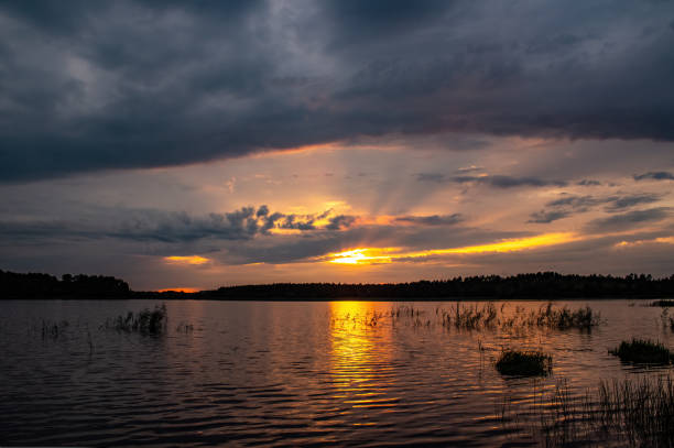 istock Colorful sunset over the lake with aggressive cloud 2150578994