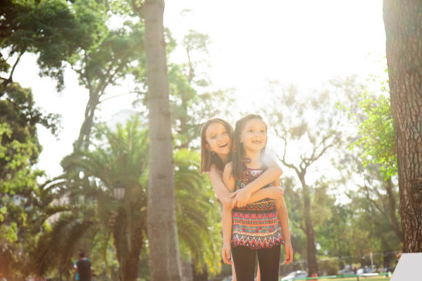 istock Little sisters having fun ourdoors 2150579868