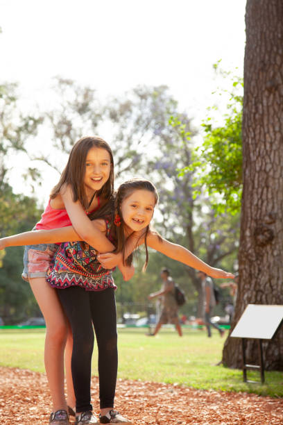 istock Little sisters having fun ourdoors 2150579896