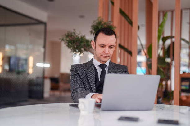 istock Businessman using mobile phone and laptop on conference table. 2150580650