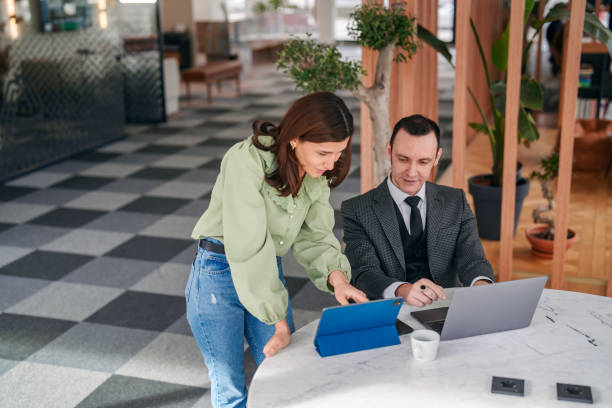 istock Businessman and his assistance working on laptop and digital tablet. 2150580947