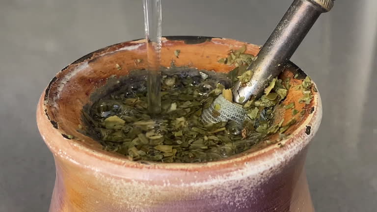 Pouring hot water into mate gourd