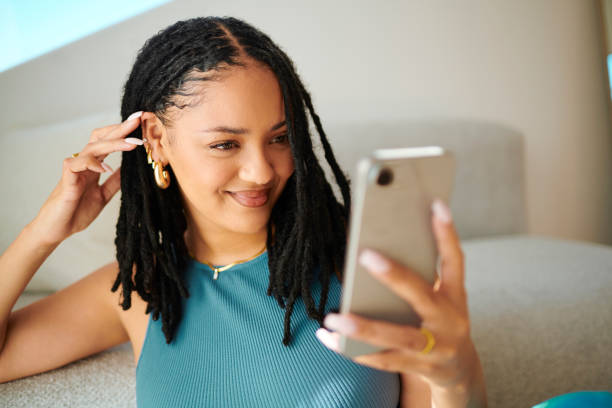 istock Joyful Relaxation: A Woman Texting On A Mobile Phone 2150583330