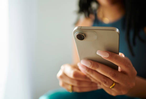 istock Connected Fingertips: Woman Texting on Mobile Phone 2150583346