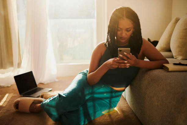 istock Joyful Relaxation: A Woman Texting On A Mobile Phone 2150583408