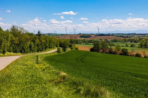 Wind turbines on the horizon on the Lauragais hills in spring from Nailloux