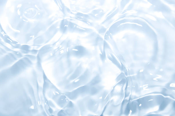 The surface of the water is transparent blue. Photo of transparent blue water surface Light passes through, slight bubbles and soft waves give a natural feel. freshness stock pictures, royalty-free photos & images