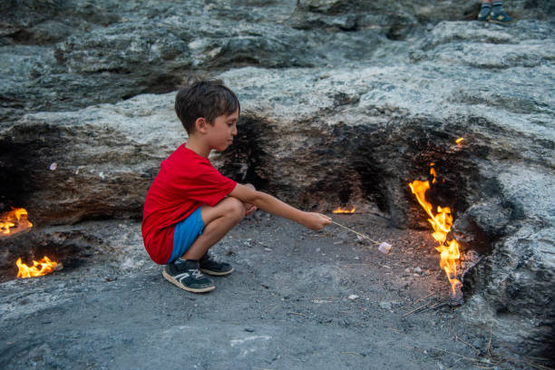 istock Boys Close-Up Roasting Marshmallows Over fire, Mount Chimaera in ancient Lycia, Antalya 2150587605