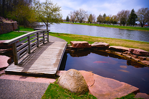Wooden Bridge over the little pond and stone footpath at Terrace Park Japanese Gardens in Sioux Falls, South Dakota, USA
