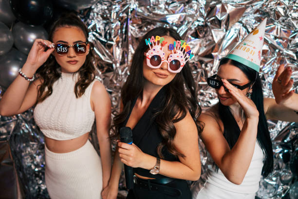 istock three friends are having fun at a birthday party. 2150590505