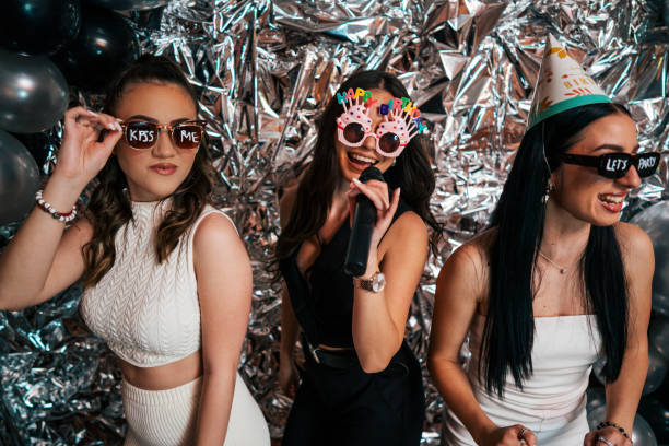 istock three friends are having fun at a birthday party. 2150590579