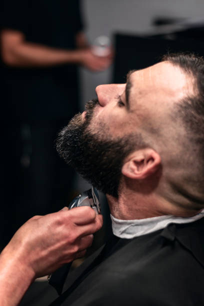 istock Close-up of a man having his beard trimmed. 2150591152