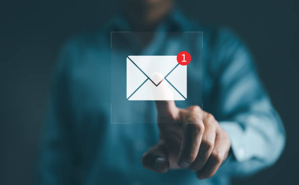 istock New email notification interaction concept. A person interacting with a floating digital interface showing a new email notification symbol, a concept for online communication. E-mail marketing, 2150592881