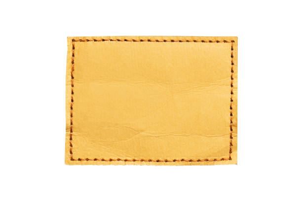 istock Brown leather belt strap closeup isolated on white. Brown stitched leather seam frame label tag isolated on white. 2150593906