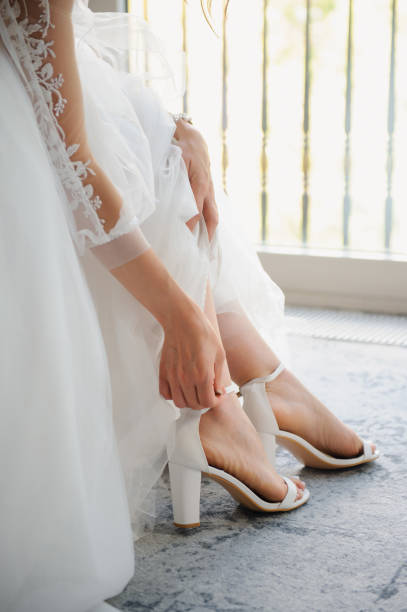 istock woman's legs in sandals. 2150594674