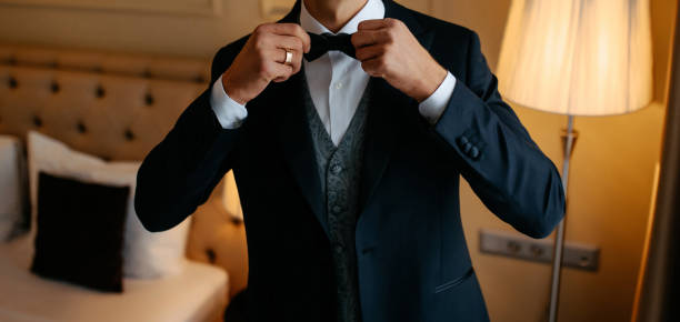 istock groom in elegant tuxedo arranging his jacket. 2150594819
