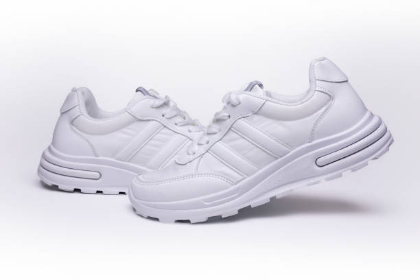 istock Women's white sneakers on a white background 2150595107