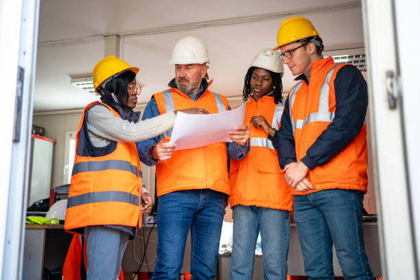 istock Building contractor and engineers working in office at the construction site 2150598593