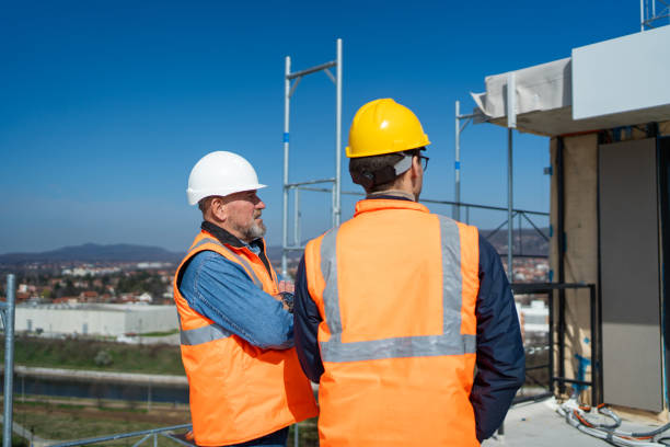 istock Site manager talking with construction worker on rooftop of building 2150599066