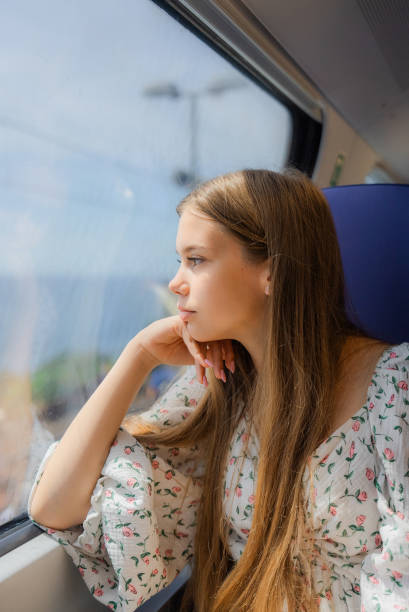 istock Girl travelling to the seaside by train 2150599475