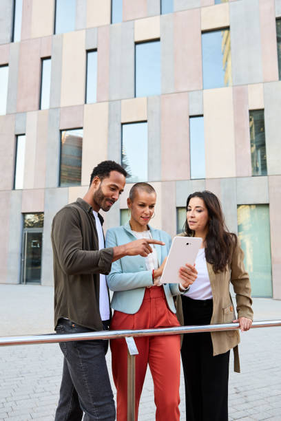 istock Confident diverse businesspeople working with tablet outside office 2150600697