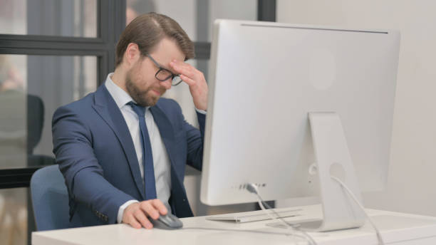 istock Young Businessman with Migraine Working on Computer 2150600926