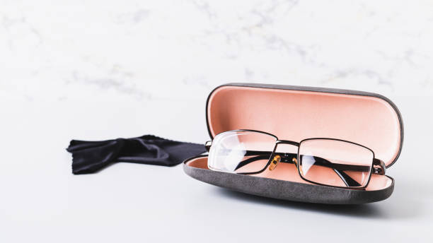 istock Eyeglasses in open hard case and cleaning cloth on table web banner 2150602517