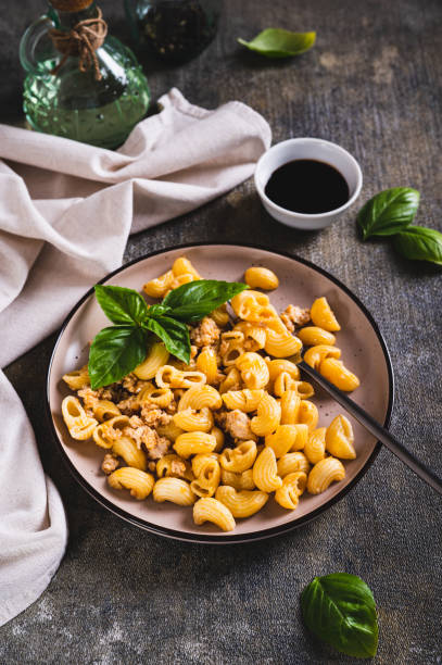 istock Navy pasta with ground meat in a plate on the table vertical view 2150602569