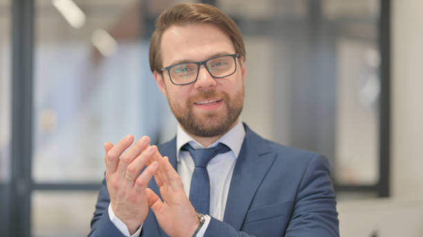 istock Portrait of Middle Aged Businessman Clapping for Team 2150602849