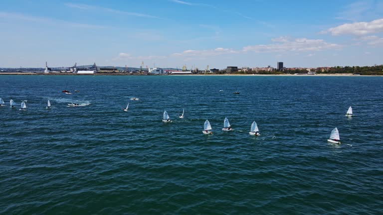 Sport Orbit Shot of Many Kids Sailing School Ocean Waves Good Winds Summer