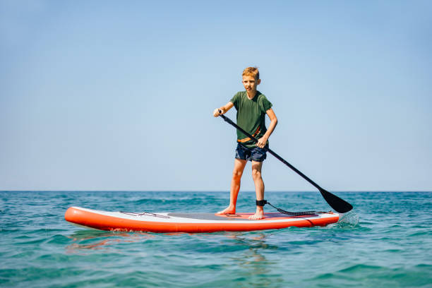 istock Young Boy Sup Surfing on the Sea 2150604529