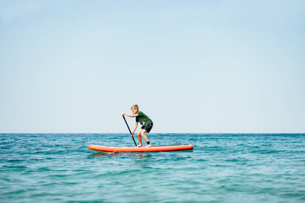 istock Young Boy Sup Surfing on the Sea 2150604540