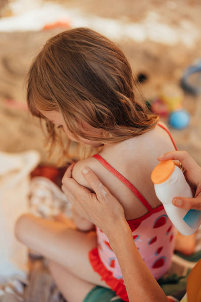 istock Unrecognizable Mother Applying Sunscreen Lotion to Her Anonymous Girl’s Back 2150604572