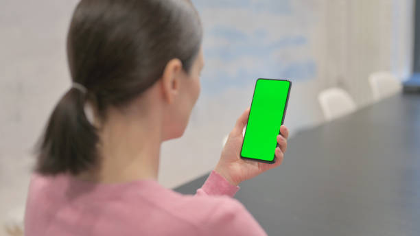 istock Holding Smartphone with Green Chroma Key SCreen 2150607319