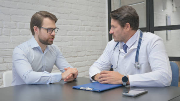 istock Young Man Talking with Doctor in Clinic 2150607418