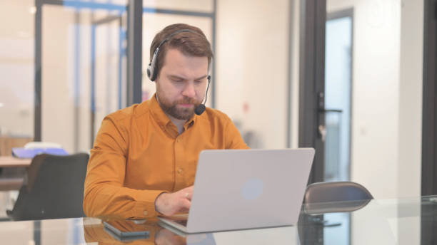 istock Young Man with Headset Working in Call Center 2150607739