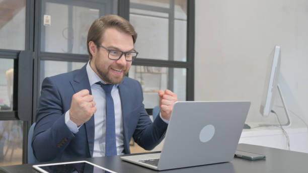 istock Young Businessman Cheering Success on Laptop 2150607758