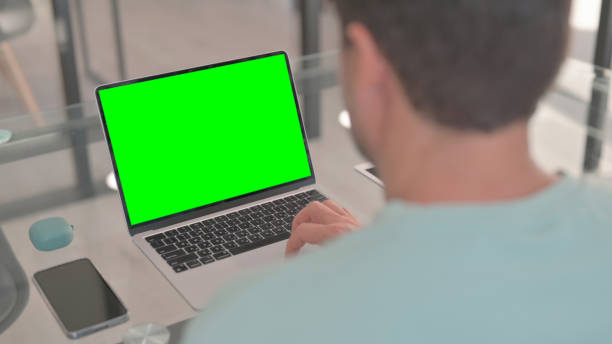 istock Man Working on Laptop with Green Screen Chroma Key 2150607767