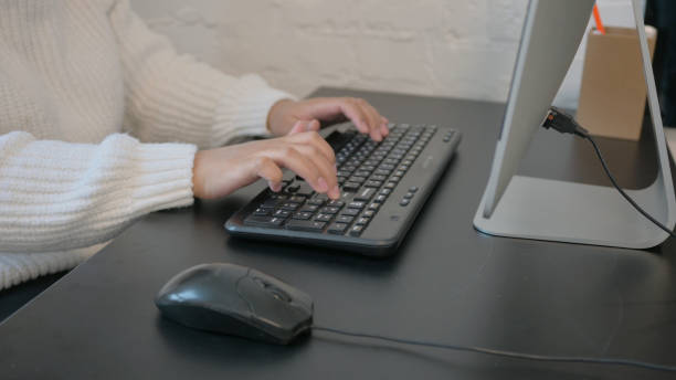 istock Close up of Female Hands Typing on Keyboard 2150607988