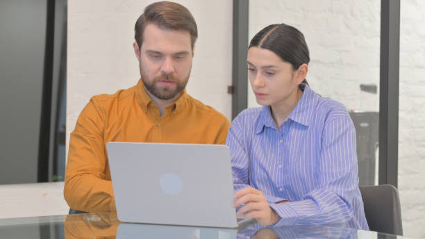 istock Business People Discussing Project while Sitting in Office 2150608376