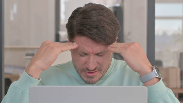istock Close up of Man having Headache at Work 2150609738