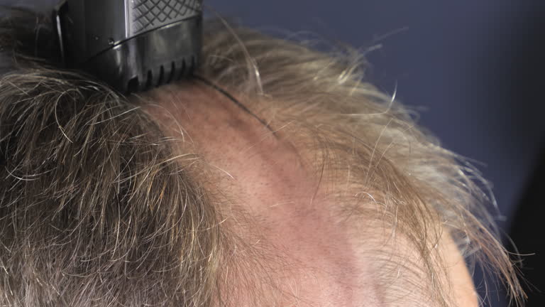 A closer look at how a man's head is shaved into a wedge at home.